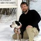 David Lee on one knee with dog